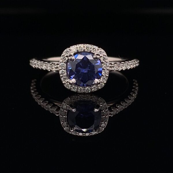 This Diamond Halo Engagement ring features a 1.00ct Round Blue Sapphire and is available for only $1500!!! Inquire Now!!