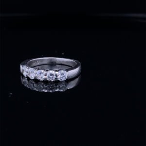 Five diamond engagement ring on black surface