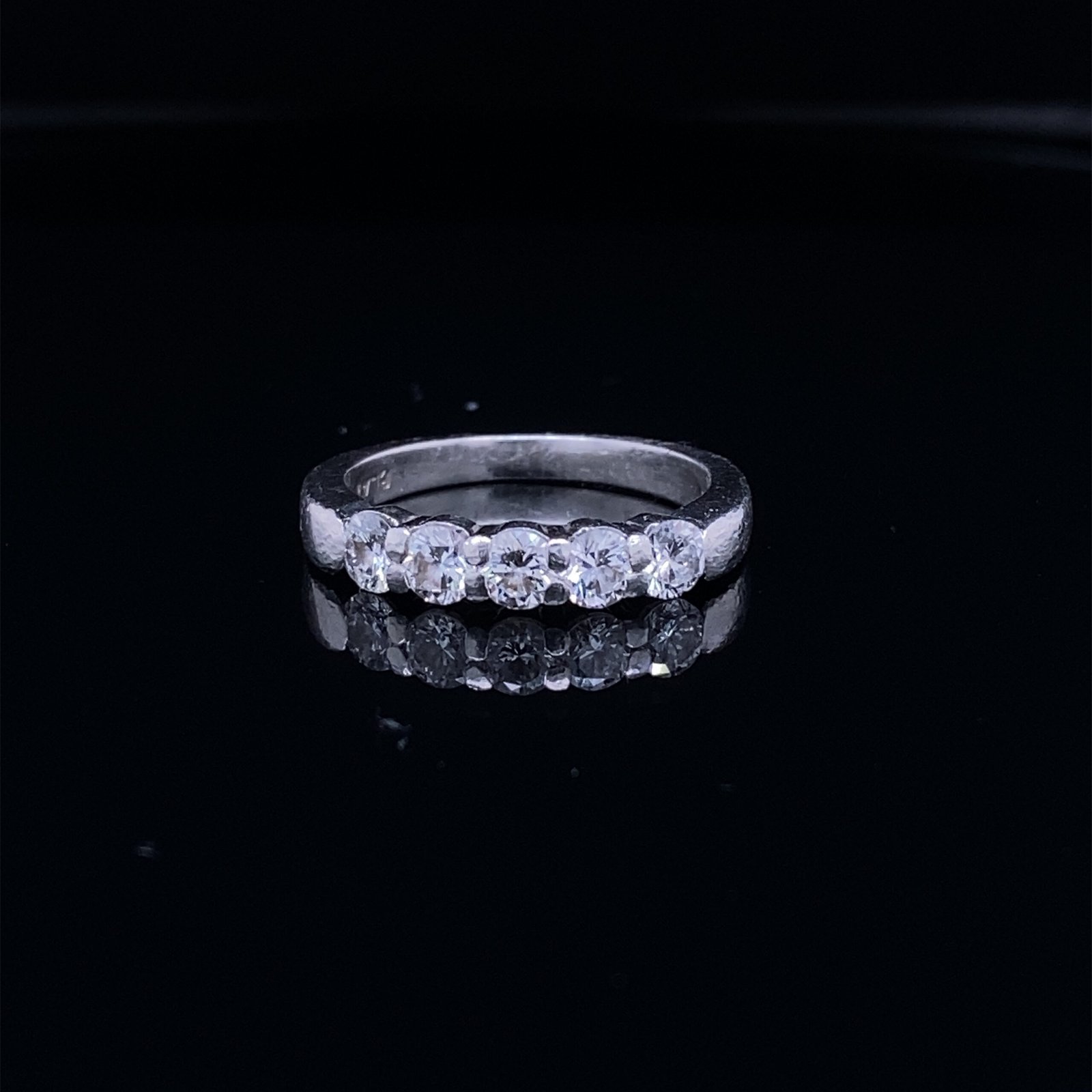 Silver ring with five round clear gemstones