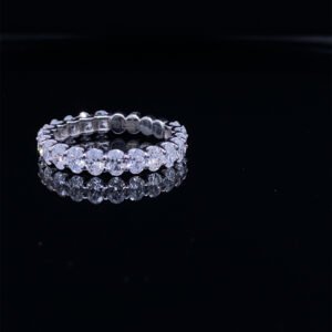 Diamond eternity ring on black reflective surface