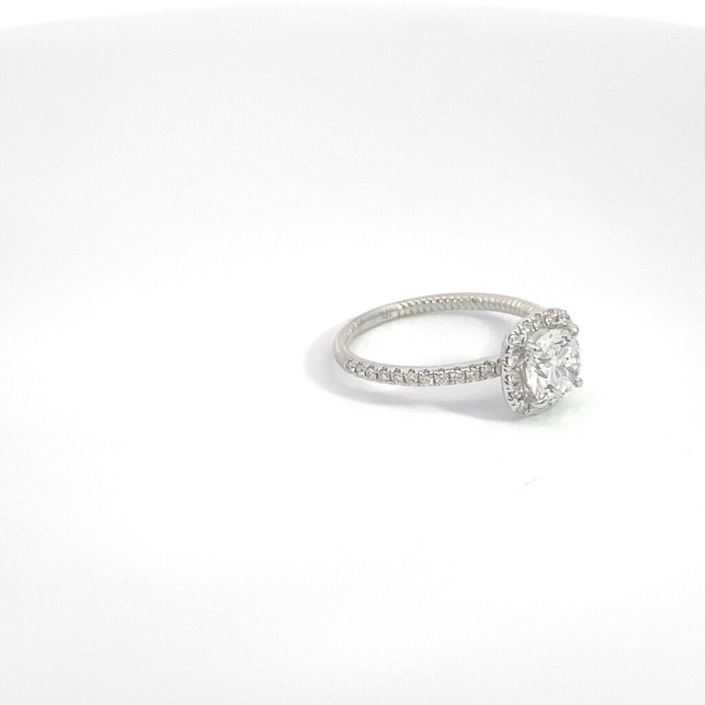 halo diamond engagement ring on white background