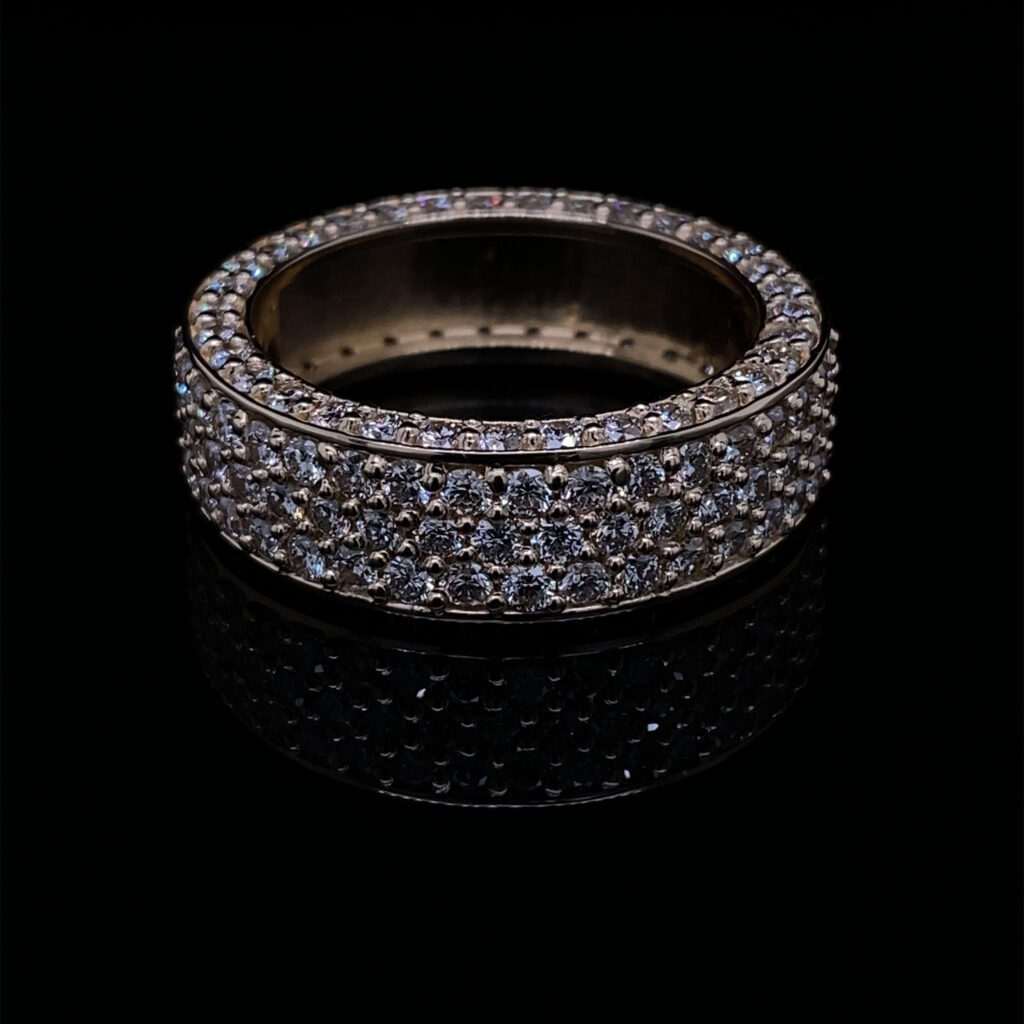 Gold pave diamond ring on black background