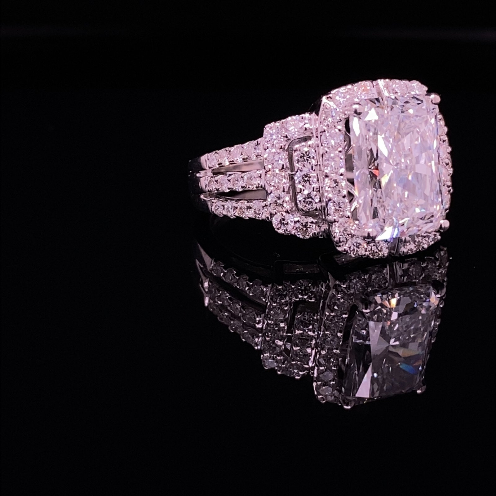 Cushion-cut diamond halo engagement ring reflection