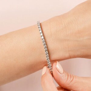 Close-up hand fastening diamond tennis bracelet Close-up hand fastening diamond tennis bracelet