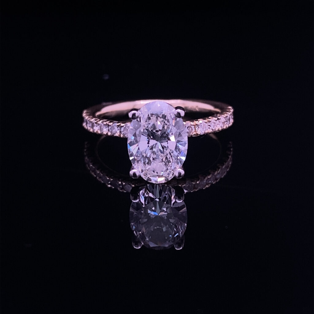 Oval diamond pave engagement ring reflection