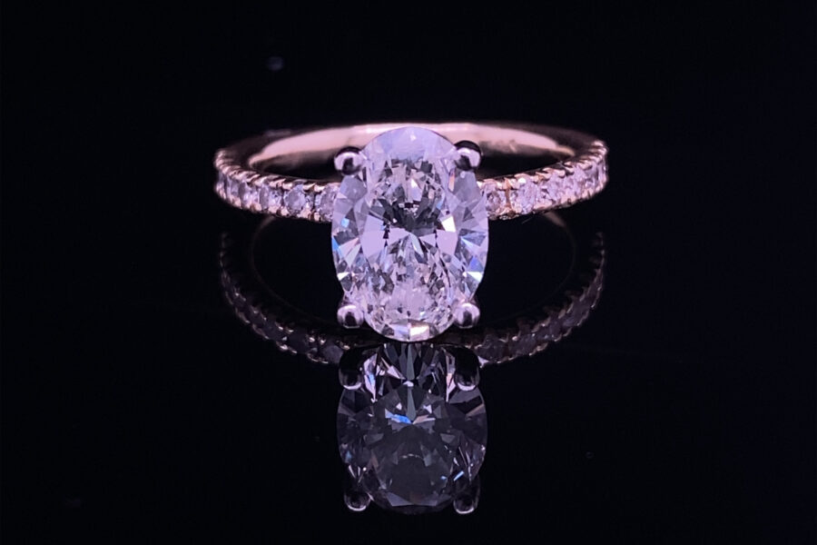 Oval diamond pave engagement ring reflection