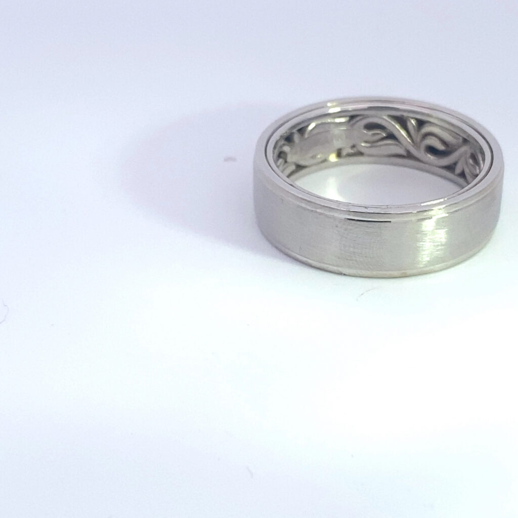 Silver wedding band with filigree interior