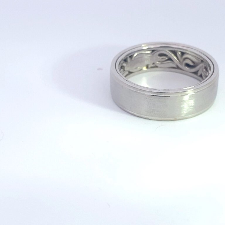 Silver wedding band with filigree interior