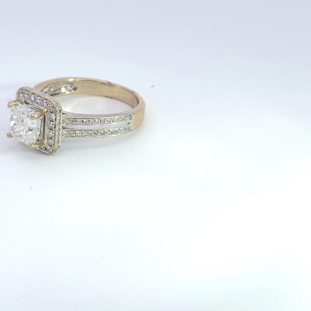 Diamond halo engagement ring on white background