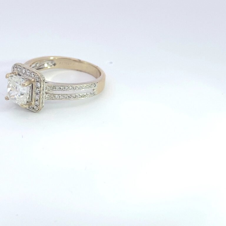 Diamond halo engagement ring on white background
