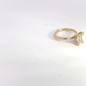 Gold engagement ring with emerald-cut diamond 14K yellow gold solitaire ring with 2.03 carat emerald-cut E VS1 lab-grown diamond, shown in side view