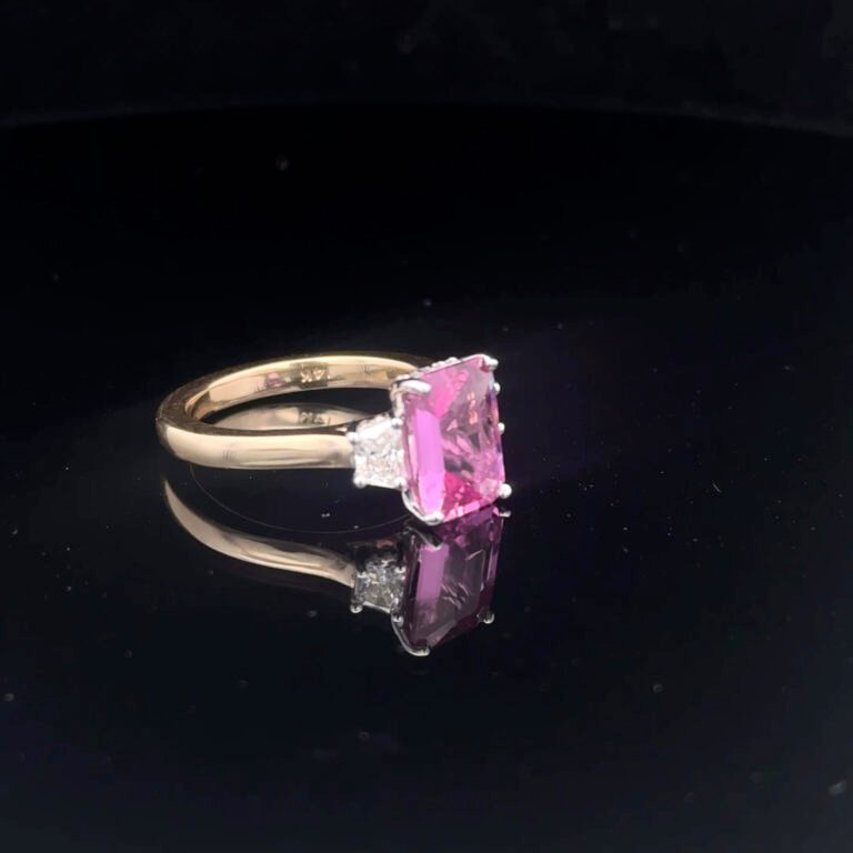 Gold ring with pink gemstone and diamonds