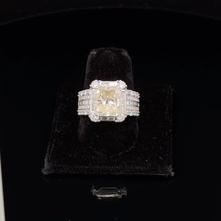 Yellow diamond ring on black velvet display